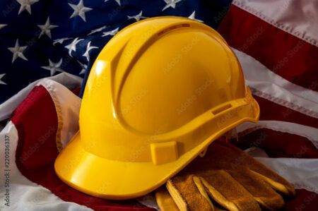 A yellow hard hat on an American flag