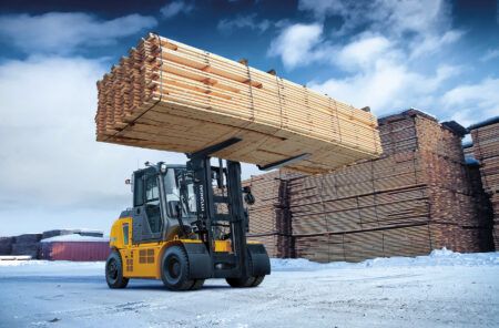 A B-X series forklift lifting lumber on a wood factory