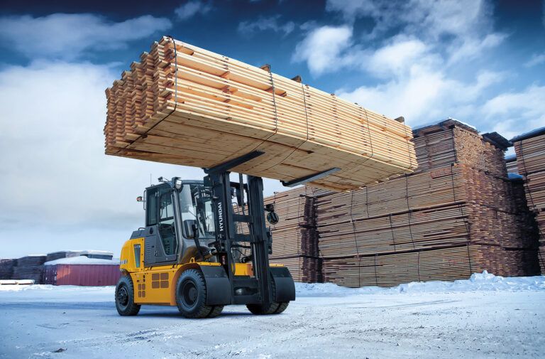 A B-X series forklift lifting lumber on a wood factory