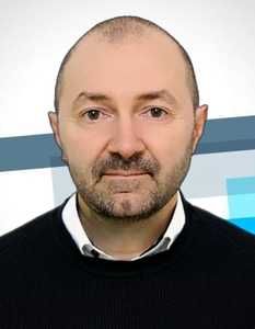 Headshot of white middle aged man, balding with short cropped beard