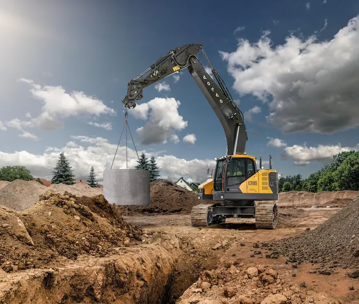 Finalists Introduced for 2025 Transition Trucking: Using for Excellence Award - Machinery Asia New Volvo ECR355 excavator lifting large concrete cylinder with boom extended, demonstrating enhanced lifting capacity on utilities project