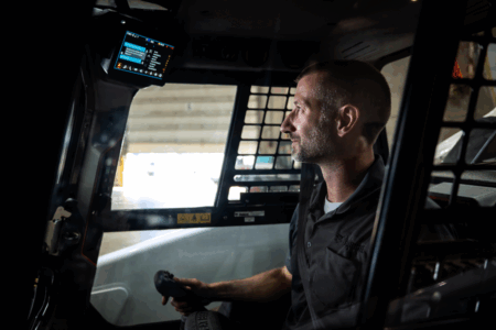 Bobcat integrates AI, autonomy and electrification across CES 2026 lineup An operator in a Bobcat machine using Jobsite Companion