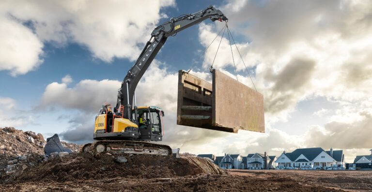 Volvo CE's ECR255 short-swing excavator lifting materials