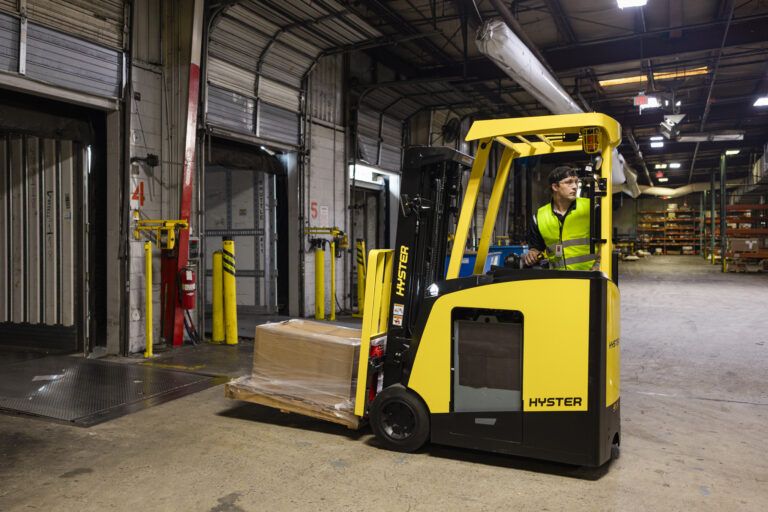 Hyster makes improvements to three-wheel stand up forklift An operator in the Hyster forklift