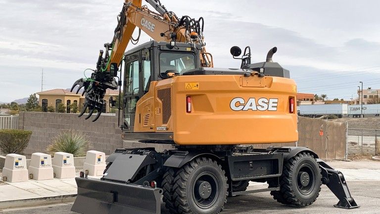 A Case wheeled excavator fitted with a grapple attachment, photographed at an outdoor location in Las Vegas