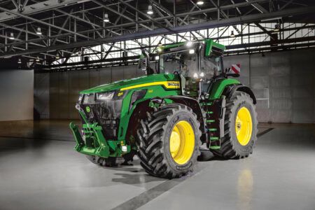 John Deere launches world’s most powerful standard-design tractor with new 8R/8RX lineup A John Deere 8R 540 tractor photographed in an indoor facility, showing the machine's front three-quarter profile with dual front wheels and front hitch attached.