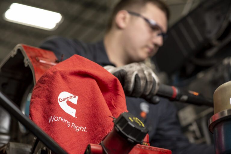 CONEXPO 2026: iVT’s technology roundup A technician works on a Cummins engine in a workshop, with a red Cummins-branded 'Working Right' cloth in the foreground
