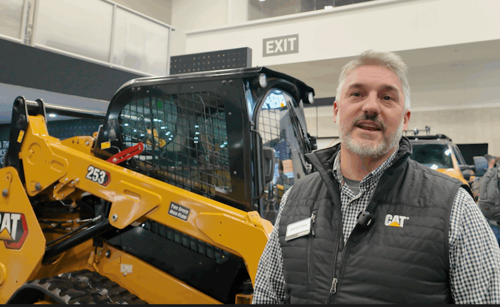 Dustin Adams, product commercial manager for compact track loaders at Caterpillar, standing alongside the Cat 253 compact track loader on the company's ConExpo stand.