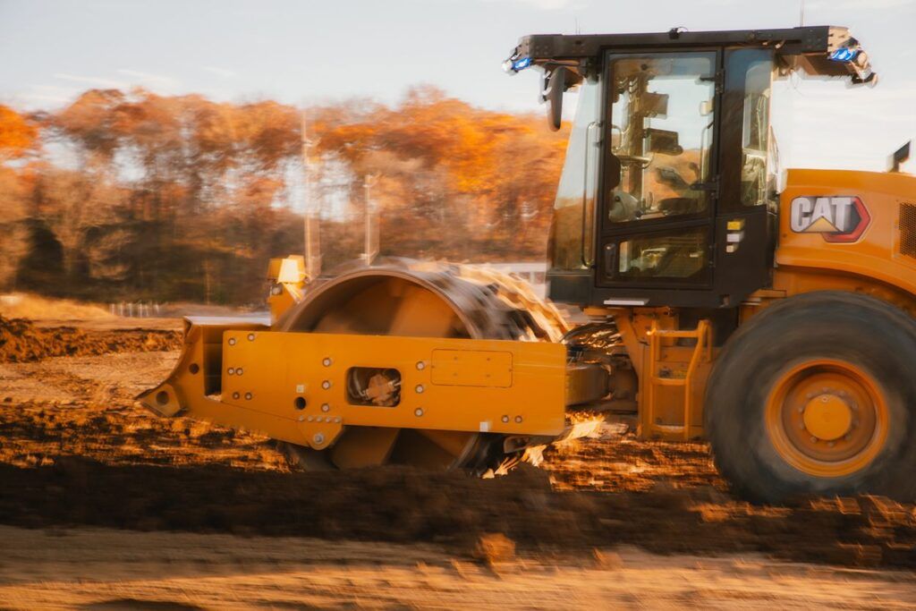 soil compactor operating with no one in the cab with motion blur