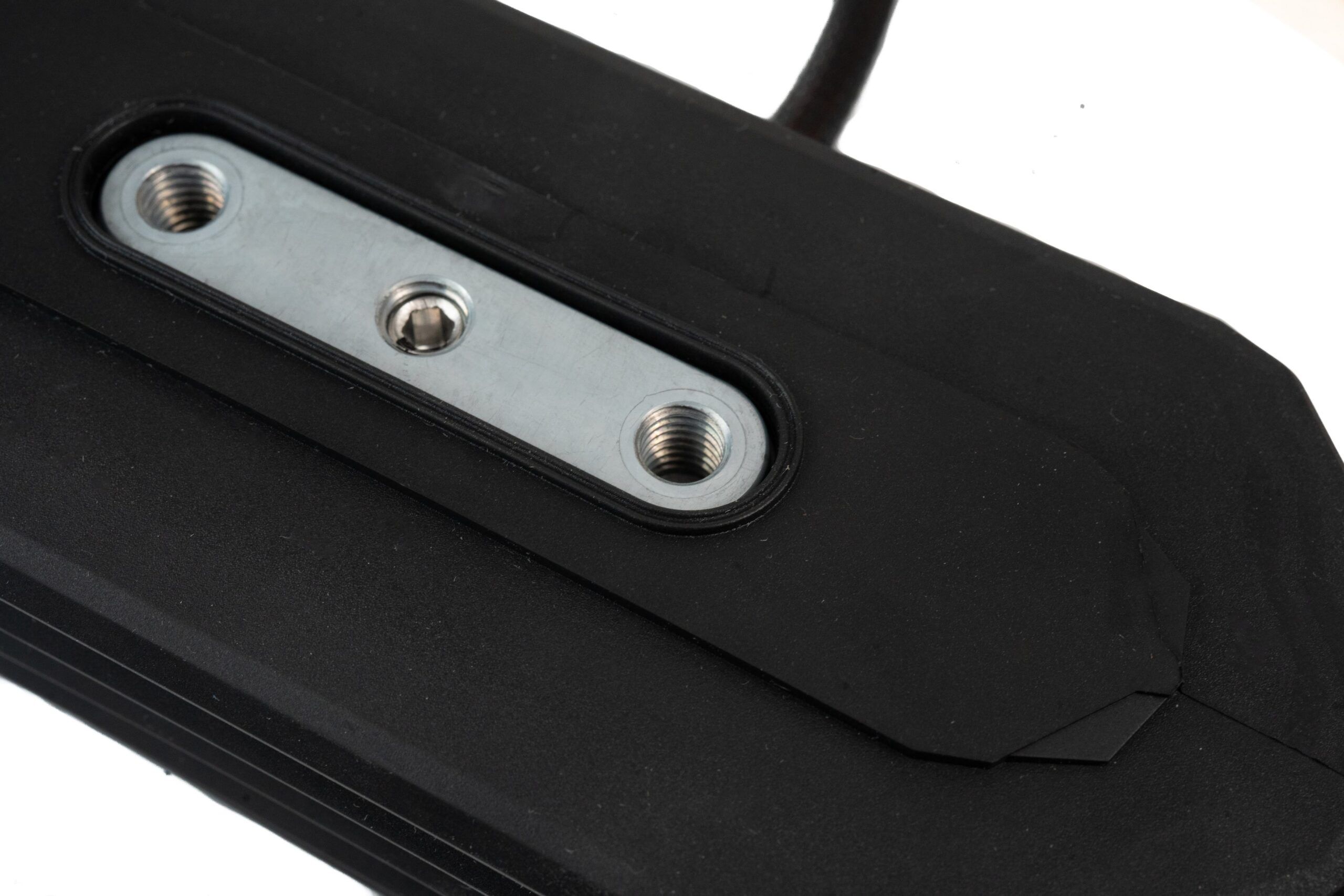 Close-up of the underside mounting plate of the Curtiss-Wright WM-G75 rocker pedal, showing three threaded fixing points within a sealed black housing