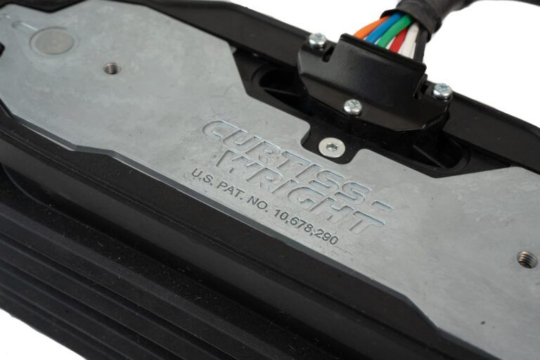 TECHNOLOGY PROFILE: Designing the next-generation of operator controls for off-highway OEMs Detail of the Curtiss-Wright WM-G75 rocker pedal showing the embossed manufacturer name, US patent number and a colour-coded wiring harness exiting a sealed connector