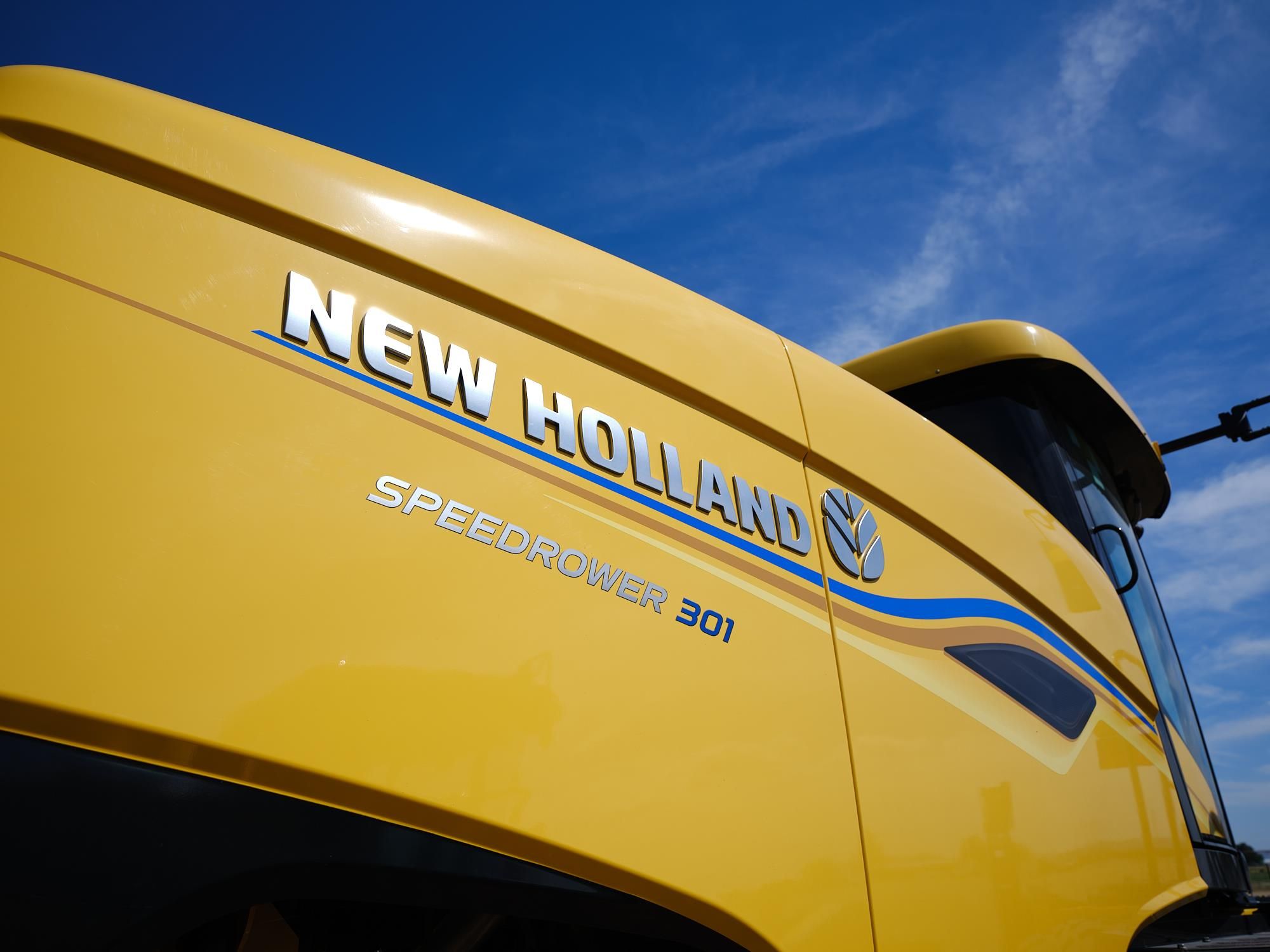 New Holland Speedrower 301 self-propelled windrower with disc header working in a field