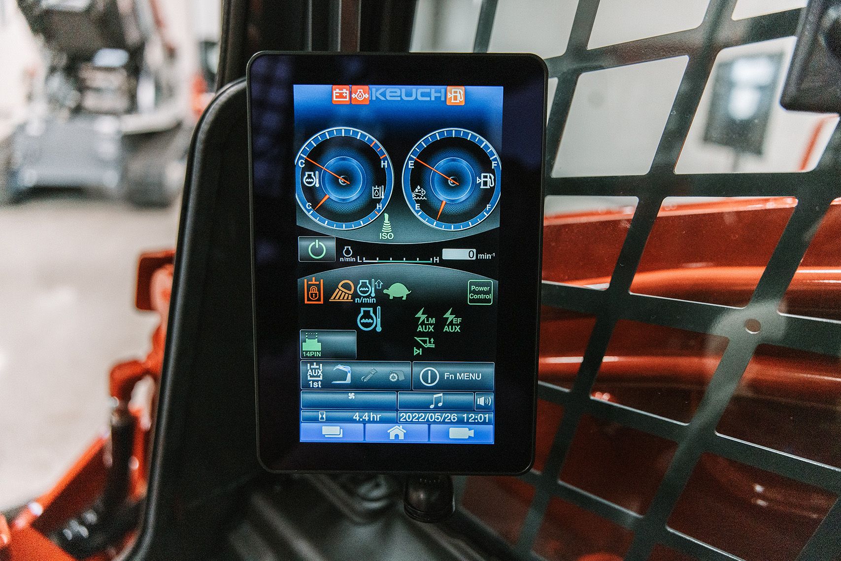 Close-up of the Takeuchi TL11R3 touchscreen monitor showing machine gauges and settings