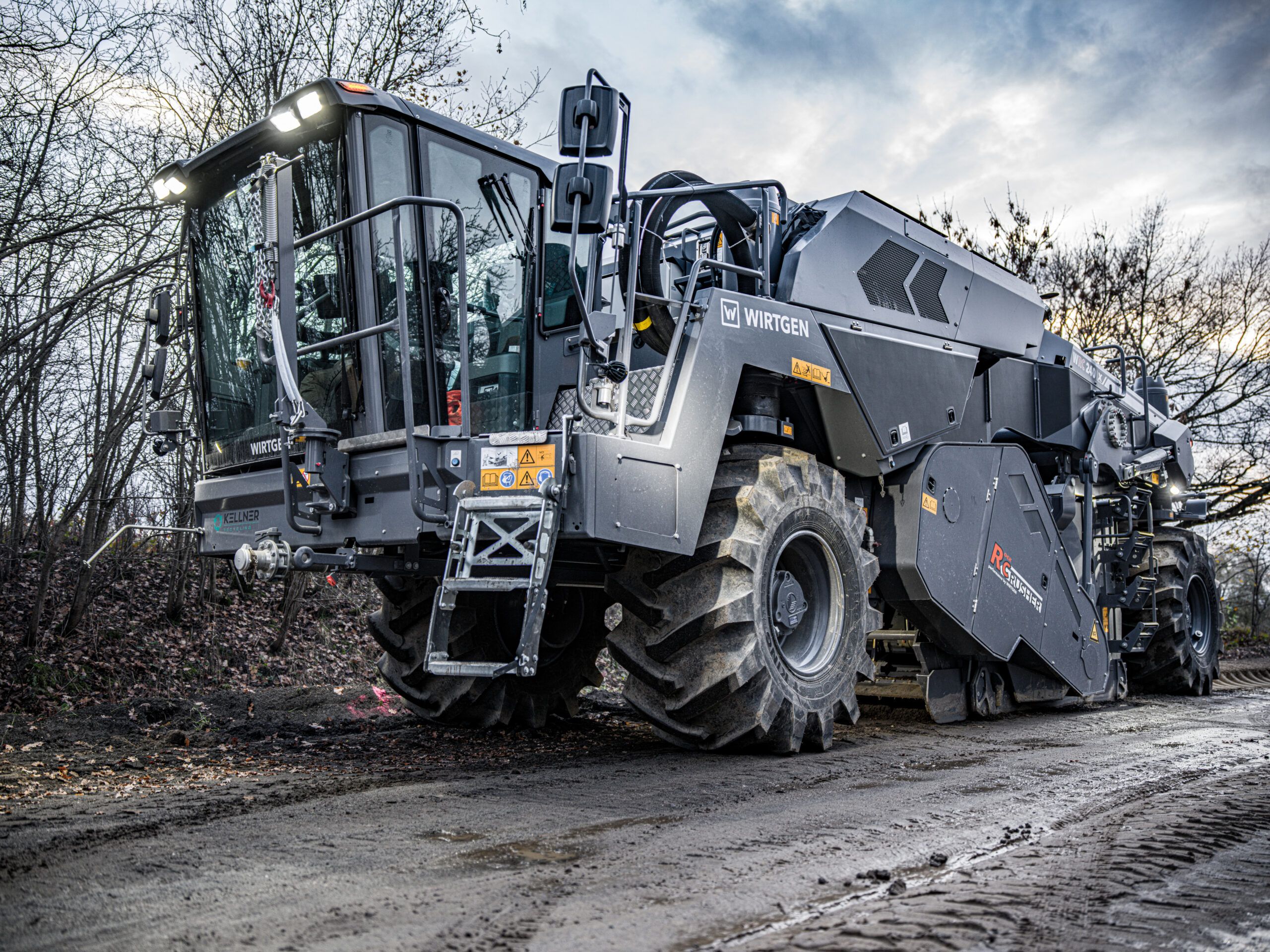 The Wirtgen WRC 240 X mobile wheeled rock crusher parked on a track, viewed from the front three-quarter angle