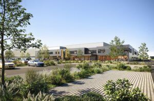 Architectural rendering of the new Liebherr Nambsheim facility, a long low industrial building with landscaped grounds under a blue sky