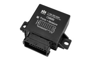 A compact black measurement module with a multi-pin connector on the front face and a wiring diagram printed on the top housing