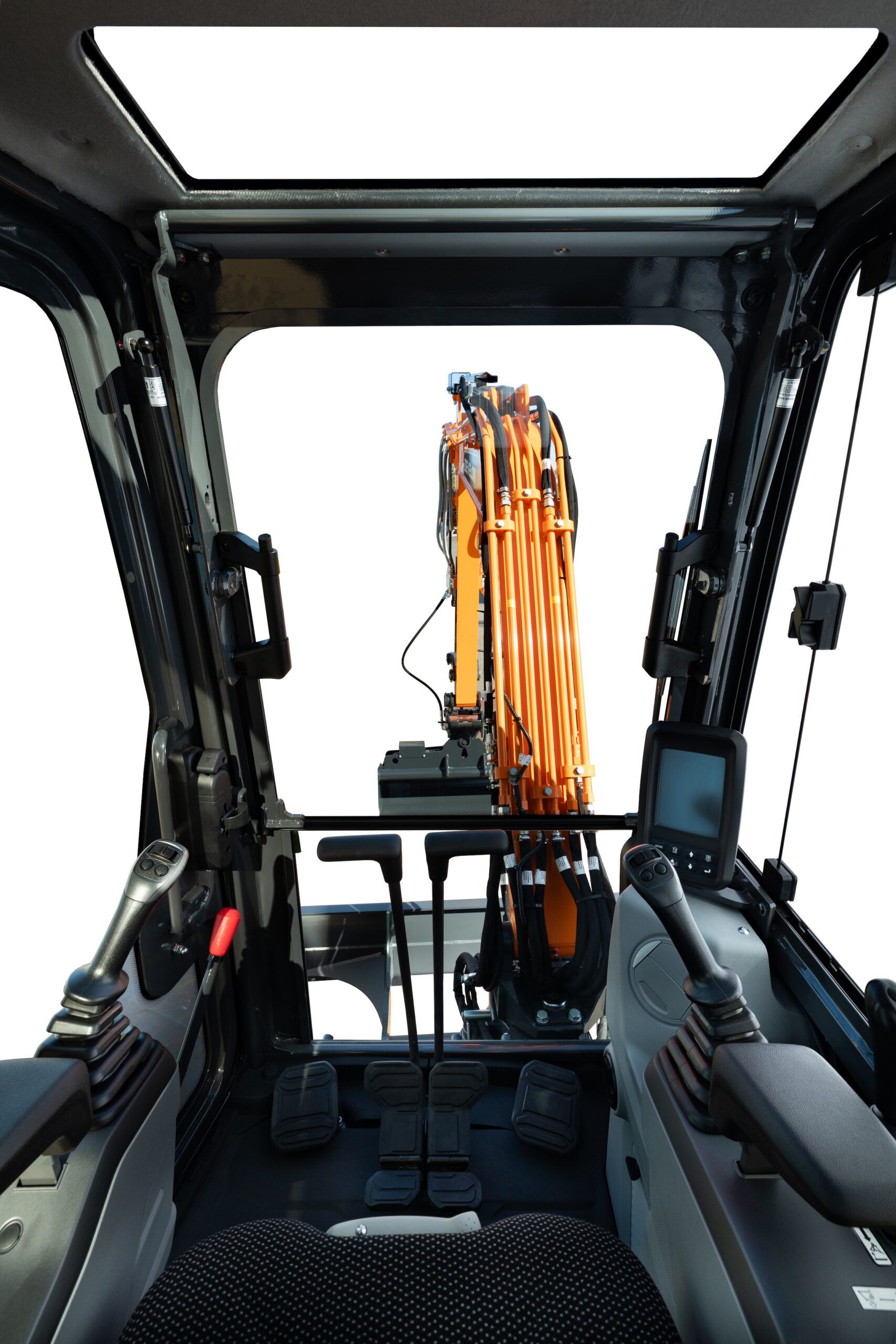 Interior view of the DX35Z-7 cab looking forward through the front glass, showing twin joysticks, foot pedals and a colour monitor.