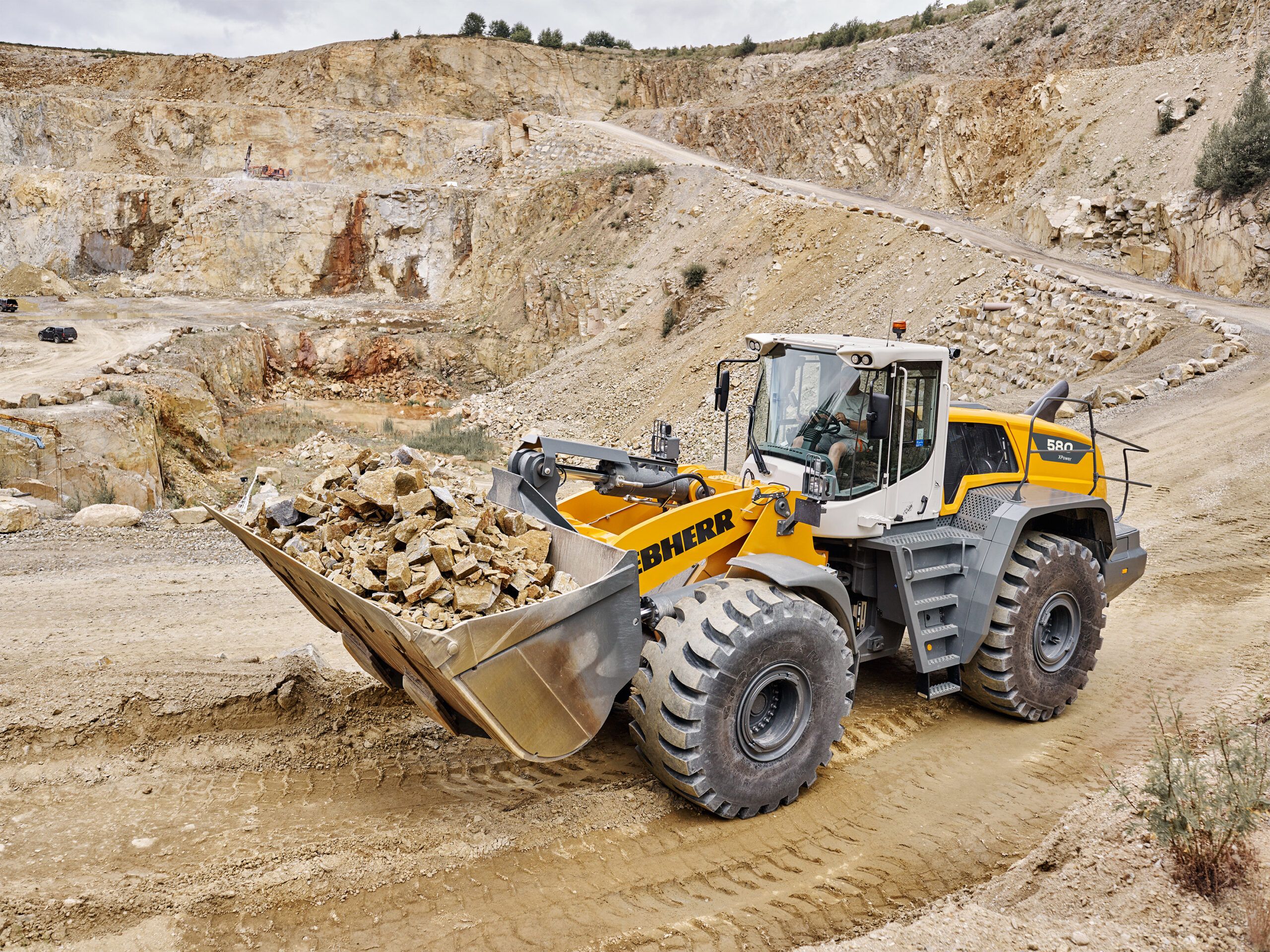 Liebherr L 580 XPower wheel loader with a full rock bucket working in a quarry