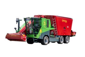 : A green and red Strautmann Primus 928 self-propelled feed mixer with its front cutting unit, shown against a white background